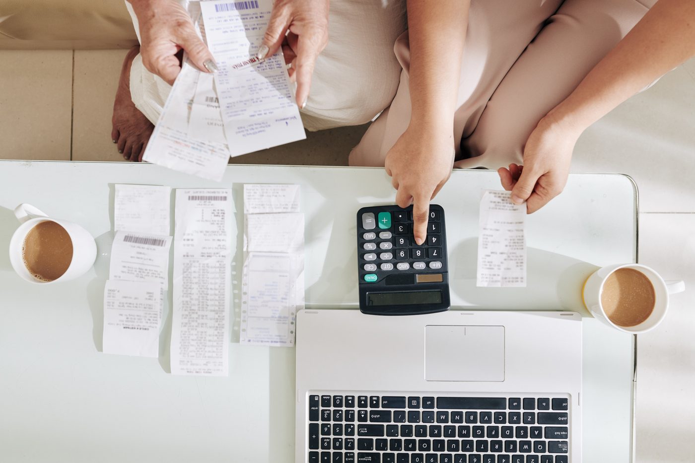 Monthly bookkeeping — receipts and calculator on a clean desk